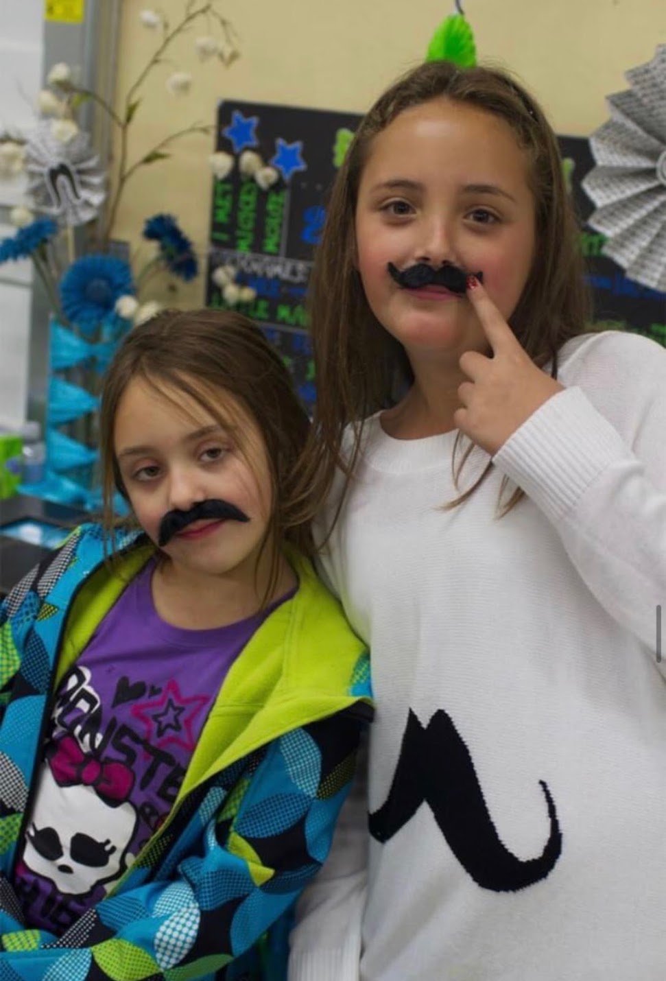 Bella as a kid with a fake mustache