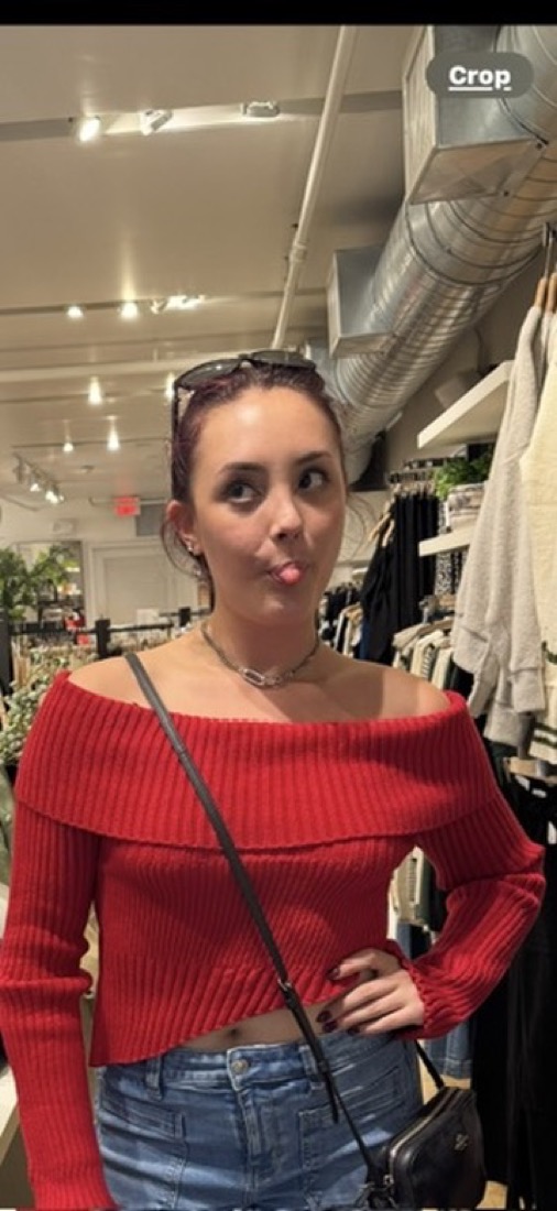 Bella sticking her tongue out in a store
